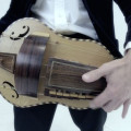 Hurdy Gurdy, flat back with guitar-shaped body made by Richard Smith, in black coffin-shaped case