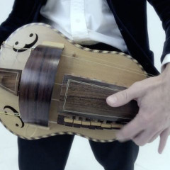 Hurdy Gurdy, flat back with guitar-shaped body made by Richard Smith, in black coffin-shaped case,